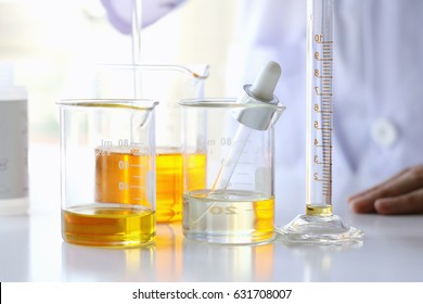 Oil pouring, Equipment and science experiments, Formulating the chemical for medicine, Organic pharmaceutical, Alternative medicine concept. (Selective Focus)