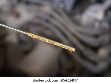 Oil probe of the car with a drop of engine oil. Maintenance of the car in the garage. - Powered by Shutterstock