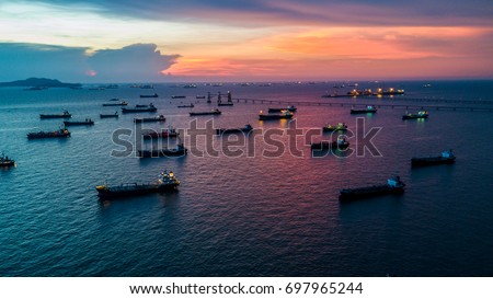 Oil product tanker chemical and gas LPG tanker ship loading in port at twilight, Business industry fuel power and energy.