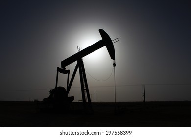 Oil Pump Hide The Sun. Desert Of Oman.