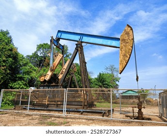 Oil Pump Jack Extracting Crude Oil from an Oil Well (2) - Powered by Shutterstock