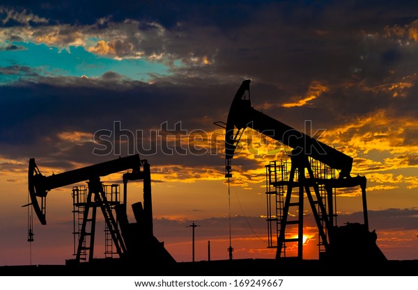Oil pump oil rig energy industrial
machine for petroleum in the sunset background for
design