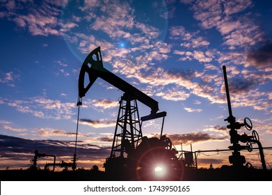 Oil pump rig. Oil and gas production. Oilfield site. Pump Jack are running. Drilling derricks for fossil fuels output and crude oil production. War on oil prices. Global coronavirus COVID 19 crisis.