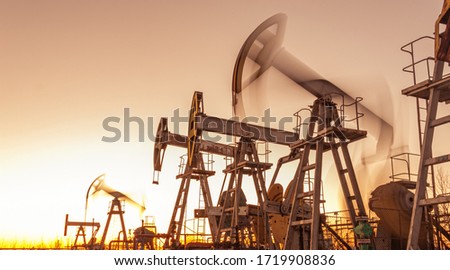 Oil pump rig. Oil and gas production. Oilfield site. Pump Jack are running. Drilling derricks for fossil fuels output and crude oil production. War on oil prices. Global coronavirus COVID 19 crisis. Stock fotó © 