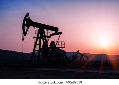 oil pump silhouette on the beautiful red sunset