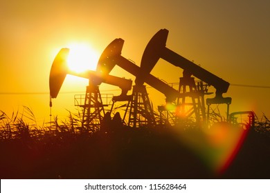 Oil pumping Unit at sunset time