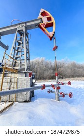 Oil Pumpjack Winter Work. Oil Pressure Gauge Shows 10 ATM (Max 15 Bar - Red Line).  A Pumpjack Is The Overground Drive For A Reciprocating Piston Pump In An Oil Well.