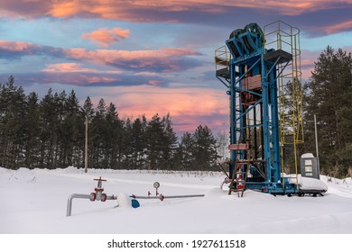 Oil Pumpjack Winter Working. Oil Rig Energy Industrial Machine For Petroleum In The Sunset Background For Design. Oil Pressure Gauge Shows 9 Kgf-cm2 (Max 26 Kgf-cm2 - Red Line)