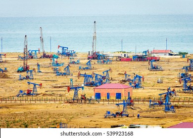 Oil Pumps And Rigs At The Field By Caspian Sea Near Baku, Azerbaijan