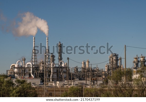Oil refineries\
and coal-fired power plants are linked to global warming and\
climate change.  Pictured is oil refinery in Freeport, Texas with\
smoke stacks emitting carbon smoke.\

