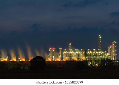 Oil refineries, petrochemical plants at night.