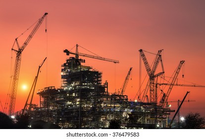 Oil Refinery Construction In Silhouette
