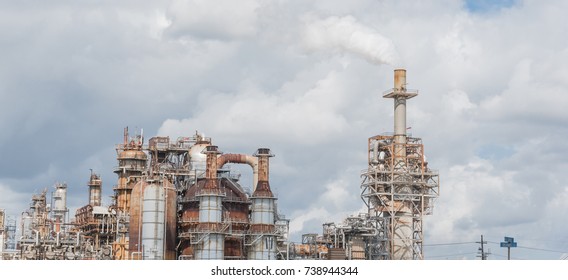 Oil Refinery, Oil Factory, Petrochemical Plant In Pasadena, Texas, USA. Air Pollution From Smoke Stacks Under Cloudy Sky. Panorama.