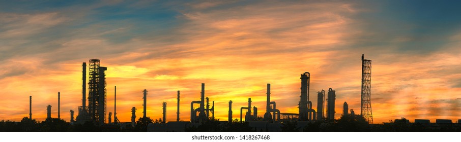 Oil refinery factory , with silhouette, Industrial zone, The equipment of oil refining, industrial pipelines of an oil-refinery plant, copy space