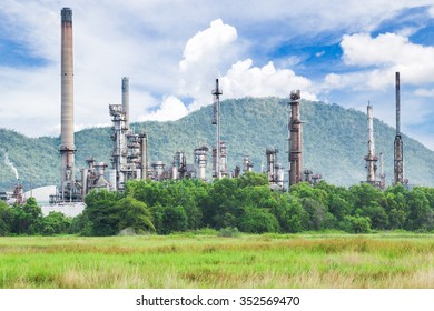 Oil Refinery With Green Grass Field