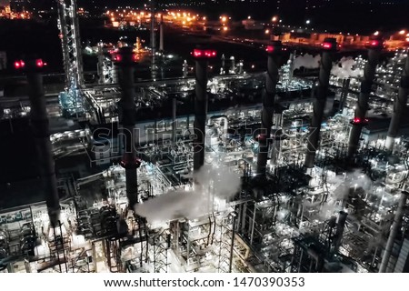 Oil refinery at night lit. Construction of an oil industrial facility. night lighting