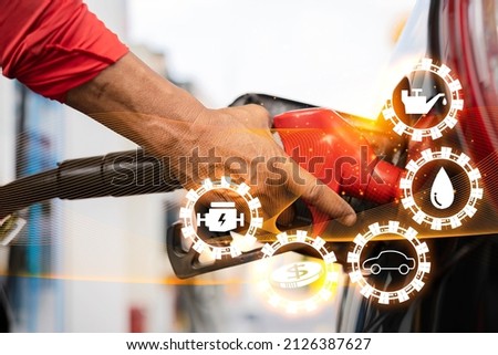 Oil refinery overlays and traffic lighting.Symbolic icons related to fuel energy.Refuel the car at the gas station at the gas station.The man refueled and refueled his car with gas at a gas station.