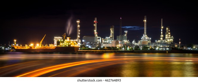 Oil Refinery Or Petrochemical Industry With Ship And Speed Light At Night In Thailand 