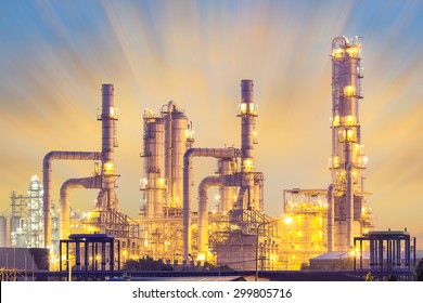 Oil refinery plant and industrial factory building with sky background at twilight, pipeline for transport oil and gas.