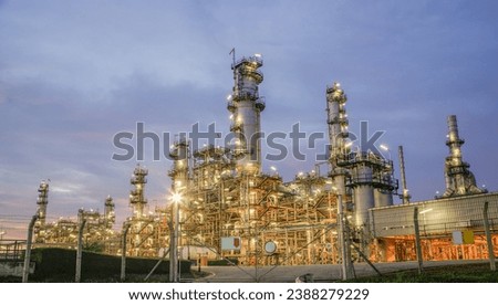 Oil refinery plant from industry zone, Aerial view oil and gas petrochemical industrial, Refinery factory oil storage tank and pipeline steel at night, Ecosystem and healthy environment concepts.