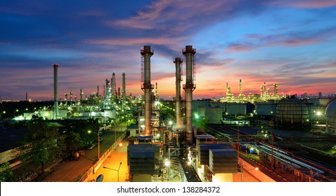 Oil Refinery Plant At Night, The Petroleum Energy And Petrochemical Factory With Column Drum And Pipeline Construction. Gas, Diesel And Chemical Production Business Industry Is Important For Economy.