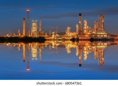 Oil Refinery At Twilight With Reflection On Water