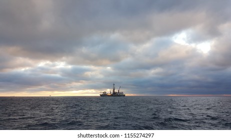 An Oil Rig In The Gulf Of Mexico At Sunset.