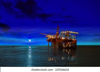 Oil Rig at night time and the moon.