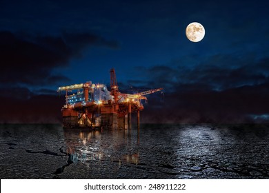 Oil Rig At Night In Winter Scenery.