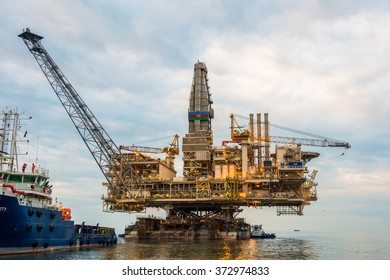 Oil rig platform in the calm sea - Shutterstock ID 372974833