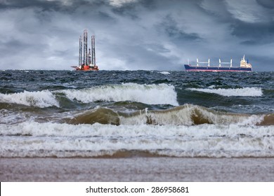 Oil Rig With Ship At Sea During A Storm.