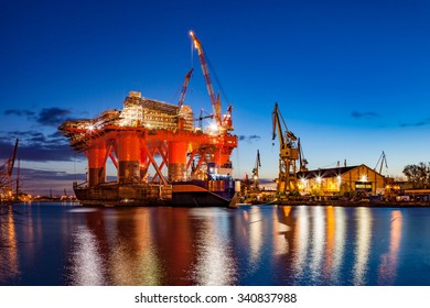 Oil Rig In The Shipyard For Maintenance At Night.