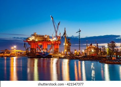 Oil Rig In The Shipyard For Maintenance At Night.