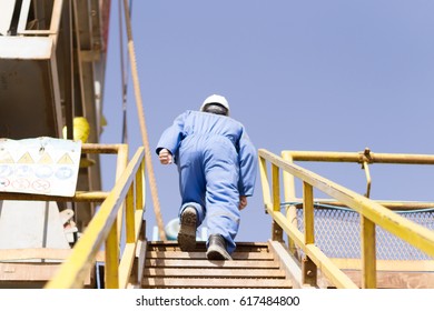 An Oil Rig Worker Going Up The Stairs