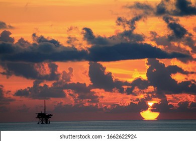 Oil Rigs And Oil Platforms At Gulf Of Mexico During Sunset