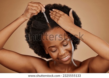 Oil serum, hair care or black woman with afro in studio on brown background for a healthy scalp. Smile, pipette or natural African girl at hairdresser salon for hairstyle treatment or beauty makeover