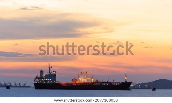 Oil ship\
Offshore construction platform for production oil and gas with\
bridge at twilight golden hour sky background\
