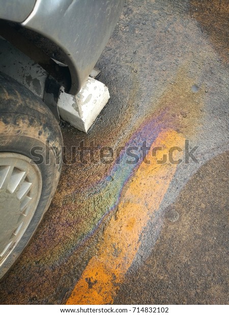 Oil slick on the\
cement out of the car