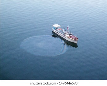 Oil Slick On Water And Water Pollution And Oil Spill From A Boat