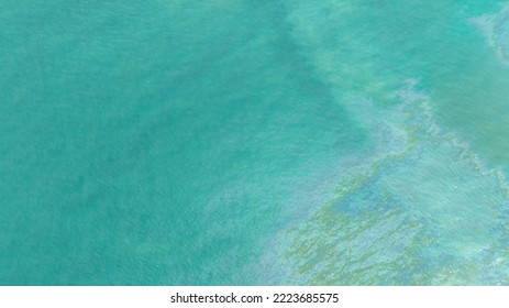 Oil Spill In Sea Water. Gasoline Leaks Into The Ocean. Dirty Water In The Ocean. Sea Water Pollution. Oil Slick On The Green Ocean Water Surface. Toxic Chemical Accident Leakage. Environment Issue.