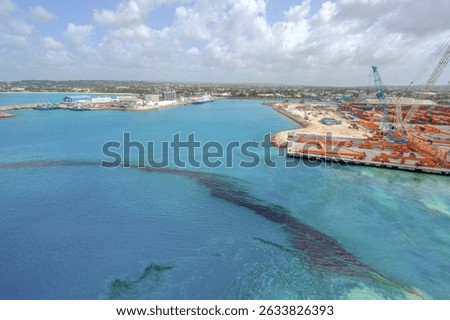 Oil spill in the turquoise waters of Bridgetown harbor Barbados showing marine pollution