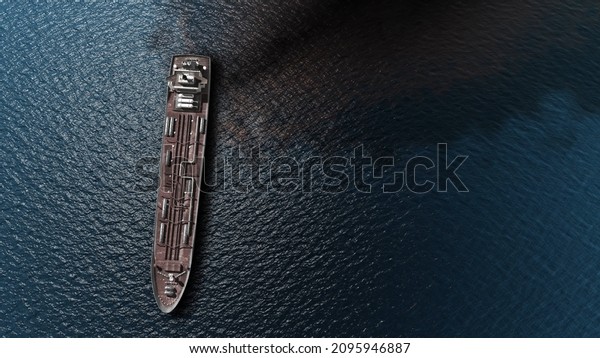 Oil spills out of a ship to Sea-\
Aerial high altitude View \
Drone view of Chemical Tanker ship\
spills oil in the ocean, global pollution concept,December\
2021\
