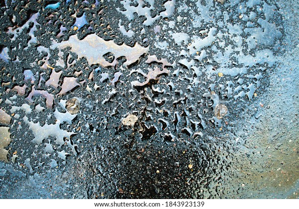 Oil\
stain on Asphalt, color Gasoline fuel spots on Asphalt Road as\
Texture or Background.Close-up Oil stain on\
Asphalt