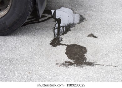 Oil Stain On The Pavement Under The Car. Dirty Asphalt Under The Car.