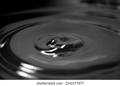 Oil stain. Wave circles from a drop on a greasy liquid surface. In the oil tank. Petroleum - Shutterstock ID 2141577477
