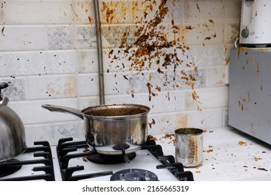 Oil stains on the walls, dirty stains on kitchen wall, Dirty Cooking. forgot to turn off the gas stove, condensed milk explosion - Shutterstock ID 2165665319