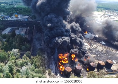 Oil Storage Fire. The Tank Farm Is Burning, Black Smoke Is The Combustion Of Hydrocarbons.