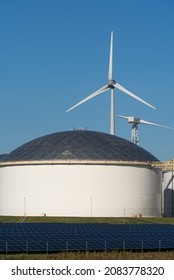 Oil Storage Tanks, Solar Panels And Wind Turbines.