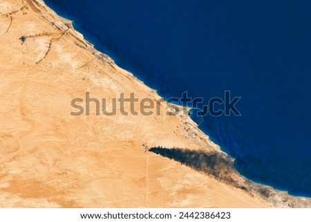 Oil Tank Fires in Libya. Military attacks sent smoke billowing from oil production facilities near Sidra. Elements of this image furnished by NASA.