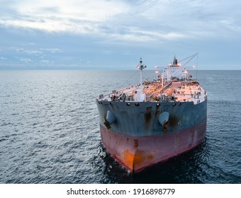 The Oil Tanker In The High Sea At Sunset